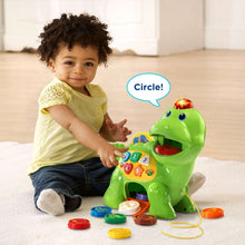 Green dinosaur learning toy with counting buttons and bite opening, with child playing