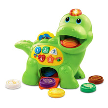 Green dinosaur learning toy with glowing head, counting keypad, and round accessory discs