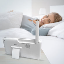 Video baby monitor parent unit with antenna on a bed