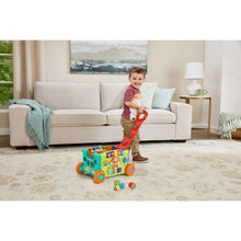 Green activity wagon toy with orange wheels, red handle, and sorting cube pieces