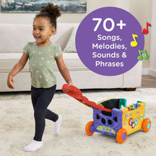 Blue and green activity wagon toy with red handle, sound panels, and colorful buttons