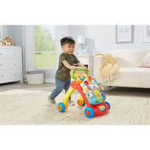 Red VTech activity walker with yellow handle, colorful learning panel, blue wheels