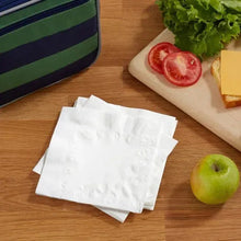 White 2-ply paper napkins, folded stack on a table