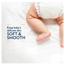 Baby skin with petroleum jelly spread, hand applying cream