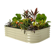 White metal raised garden bed planter filled with mixed leafy plants and orange flowers