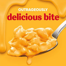 Velveeta Shells & Cheese cheese sauce on spoon, thick melted close-up