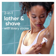 Pink Venus ComfortGlide razor held by a person during shaving in shower