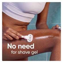 Pink Venus ComfortGlide manual razor being used on skin in the shower