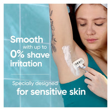 Woman shaving with a Venus manual razor on her underarm with shaving foam