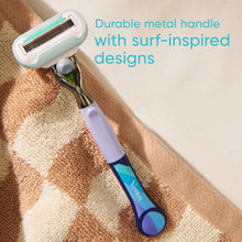 Lavender and aqua surf-style razor handle with metal blade head, angled close-up