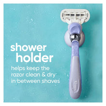 Purple manual razor handle in wall shower holder