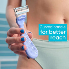 Venus razor held by hand with blue handle and metal twin blade head.