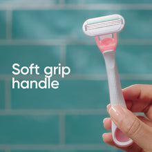 Gillette Venus Smooth Sensitive pink razor with soft grip handle, held in hand