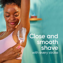 Gillette Venus Smooth Sensitive pink disposable razor shaving skin, close-up