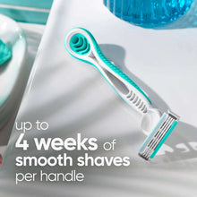 Light blue disposable razor with 3-blade head and comfort grip, close-up