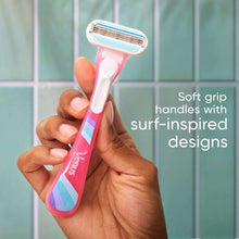 Hand holding a disposable razor with surf-inspired grip and pivoting head