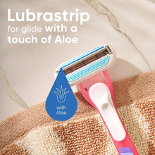 Disposable razor on a towel with a lubricating strip containing aloe