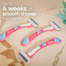 Disposable razors lying on shower floor with handles angled outward