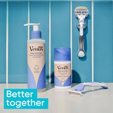 Gillette Venus razor and shaving essentials set with gel bottles on tray.