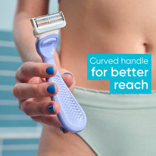 Women's intimate razor with curved handle and cartridge, held for shaving