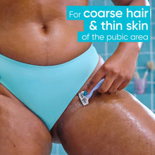 Intimate razor with twin blades and blue handle, used on pubic area