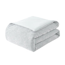Light gray comforter, neatly folded with smooth top layer