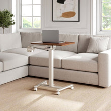 Versalift mobile desk with a laptop on its wood-grain top and a cup holder attachment