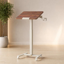 Versalift mobile height-adjustable desk with a tilting wood-grain top, white frame, and caster wheels