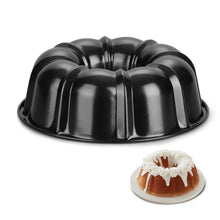 Bundt cake pan with center tube, black, close-up with mini cake beside it