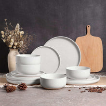 Speckled ceramic dinnerware set in light gray, including plates and bowls