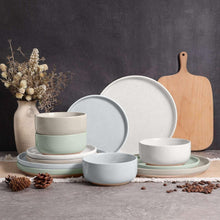 Speckled ceramic dinnerware set in white and light gray tones, plates and bowls included