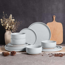 Speckled ceramic dinnerware set in light gray, including plates and bowls
