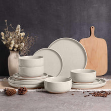 Speckled ceramic dinnerware set in soft white, plates and bowls with layered stacks