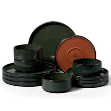 Ceramic dinnerware set with dark green bowls and plates, terracotta interiors