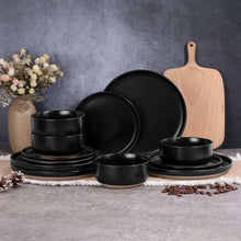 Speckled ceramic dinnerware set in matte black, including plates and bowls