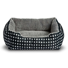 Plush pet bed with black-and-white diamond patterned exterior and gray plush interior
