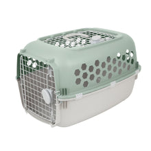 Green plastic pet kennel with two doors, top ventilation grille, and hex side openings.