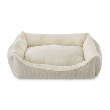 Cream luxe cuddler dog bed with raised bolster and plush inner cushion