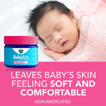 Non-medicated baby chest rub ointment jar with pink lid beside sleeping baby