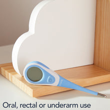 Blue digital thermometer close-up on wood surface with dark display window