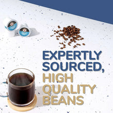 French roast coffee single-serve cups with scattered coffee beans and a brewed cup