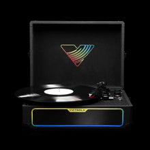 Suitcase record player with spinning vinyl, open lid, rainbow logo and colored light bar