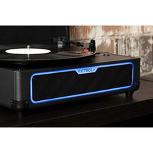 Suitcase record player front view with blue glowing light ring and speaker grille