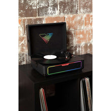 Black record player suitcase on tabletop with open lid and multicolor lighted speaker bar