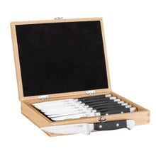 Eight steak knives in a wooden case with black handles and serrated blades