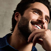Smiling man with neatly groomed beard and mustache