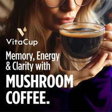 Mushroom focus coffee cup held by person with VitaCup Memory & Clarity text overlay