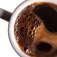 Mug of dark brown instant coffee with frothy surface