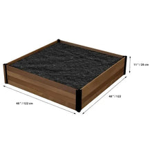 Square raised garden bed with wooden frame and dark soil, shown with dimensions