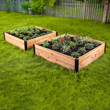 Raised garden bed 2-pack with wooden sides and black panels, filled with plants on grass